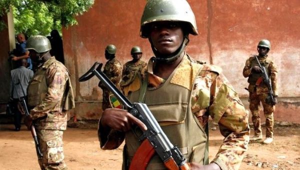 Soldiers stand guard while President Ibrahim Boubacar Keita votes.