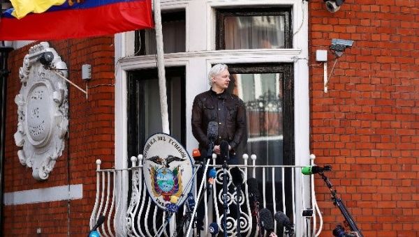 WikiLeaks founder Julian Assange stands on the balcony of the Ecuadorean embassy in London.