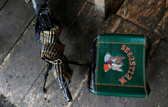 A machine gun and a chair are pictured in at a FARC camp.