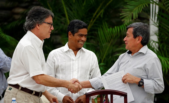 Gustavo Bell (L), Colombia government's chief negotiator shakes hands with Pablo Beltran of the ELN, after delivering a joint statement in Havana, Cuba Aug. 1, 2018.