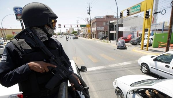 A state police patrols the streets as he and his team reinforce security in Ciudad Juarez.