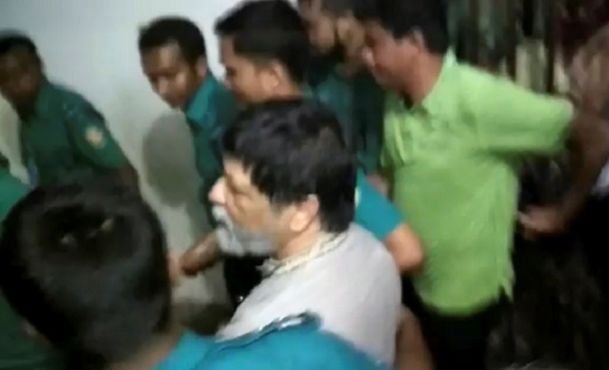 Bangladeshi photographer Shahidul Alam is dragged by plainclothes police at the Metropolitan Magistrate's court in Dhaka