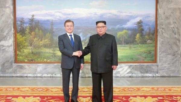 South Korean President Moon Jae-in shakes hands with North Korean leader Kim Jong Un during their summit at the truce village of Panmunjom. May 2018