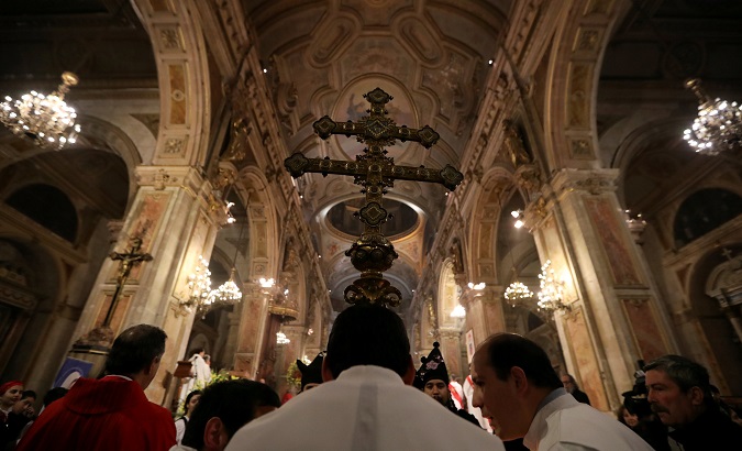 Members of the church hold a cross during a mass at the Santiago cathedral, in Santiago, Chile July 25, 2018.