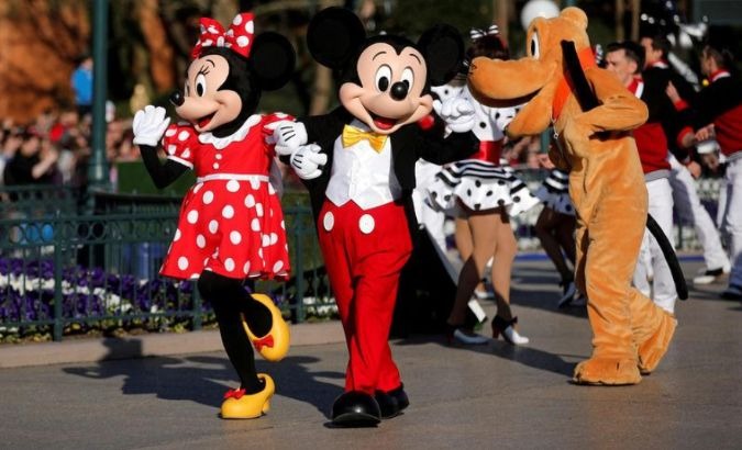 Disney characters Mickey Mouse and Minnie Mouse parade as Disney employees subsist on food stamps.