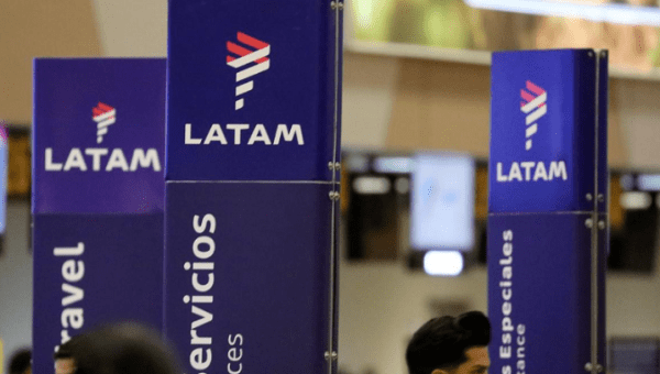 Passengers walk near the LATAM airlines counter at Jorge Chavez airport in Callao, Peru, August 16, 2018.