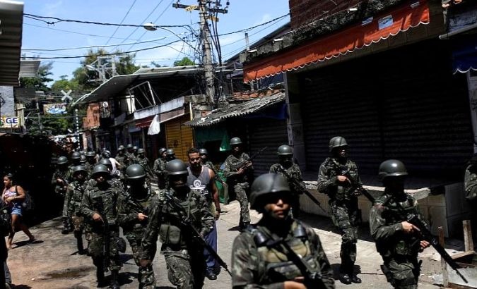 Brazilian soldier patrol a favela community.