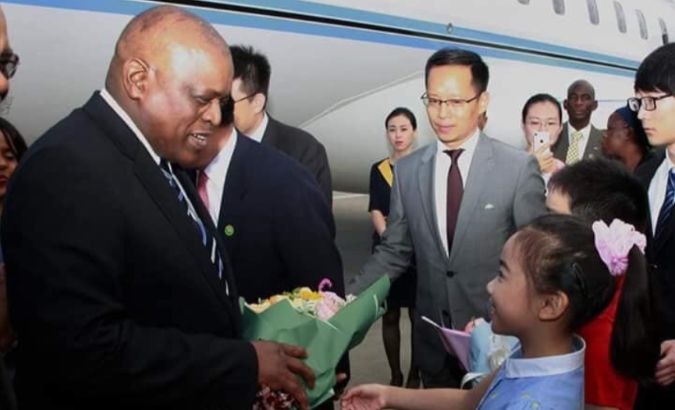 The president of Botswana, Mokgweetsi EK Masisi, is greeted upon his arrival in Beijing, China.