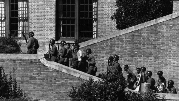 Soldiers from the 101st Airborne Division escort the Little Rock Nine students into the all-white Central High School in Little Rock, Ark.
