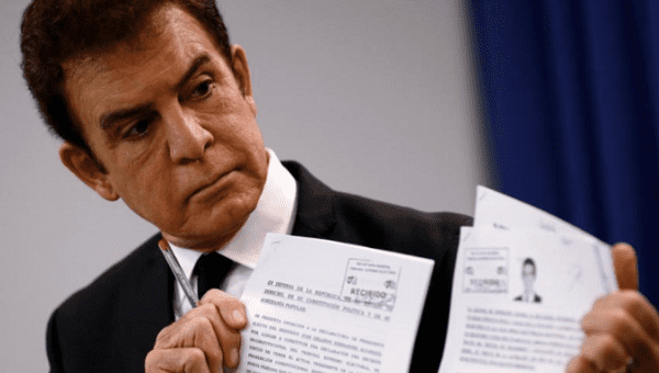 Honduran opposition candidate Salvador Nasralla displays documents filed with Honduran election officials during a news conference in Washington, 