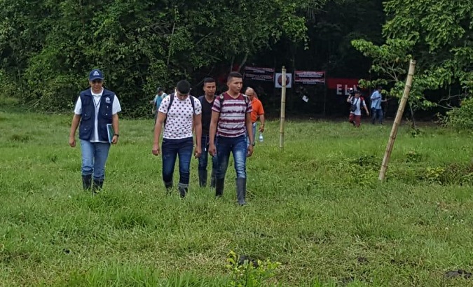 The three Colombian soldiers walk towards authorities after being released by the ELN Wednesday, Sept. 5, 2018.
