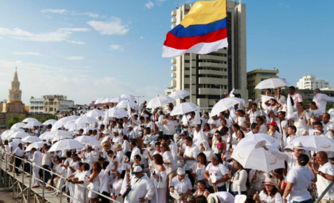People gather for the signing of the government's peace agreement with the FARC.