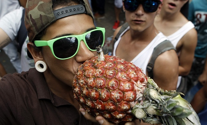 A participant smokes marijuana with a pineapple during the 2015 Marijuana World March 'The happiest day in the World' in Medellin, Colombia. May 2, 2015.