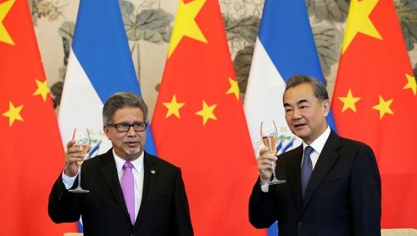Chinese Foreign Minister Wang Yi and El Salvador's Foreign Minister Carlos Castaneda at ceremony to establish diplomatic ties.