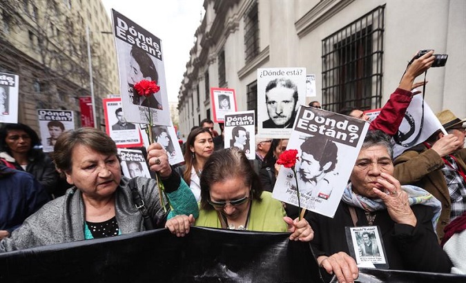 Chileans march to commemorate 45 years since the violent overthrow of Salvador Allende and the victims of the military dictatorship that followed his democratic rule.