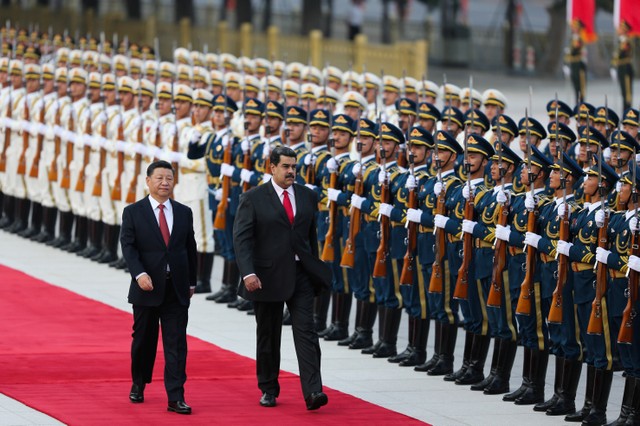 Chinese President Xi Jinping walks next to Venezuela's President Nicolas Maduro during his welcoming ceremony in Beijing, China Friday.