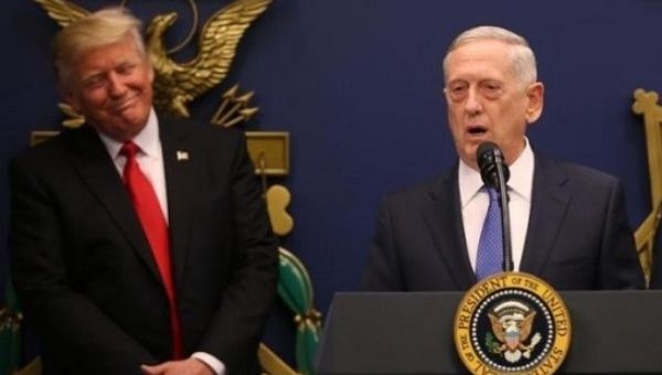 U.S. President Donald Trump listens to remarks by Defense Secretary James Mattis (R) after a swearing-in ceremony for Mattis at the Pentagon in Washington, US.