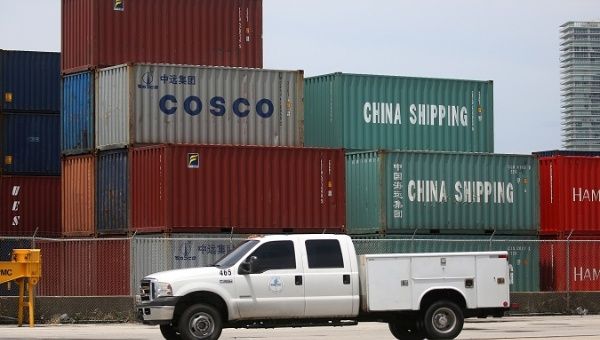 A truck drives past Cosco and China Shipping shipping containers in the Port of Miami in Miami, Florida, U.S., May 19, 2016.