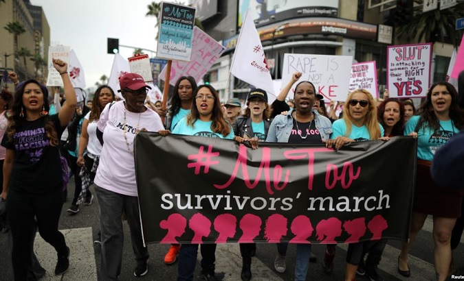 People participate in a protest march for survivors of sexual assault and their supporters in Hollywood, Los Angeles, California, Nov. 12, 2017.