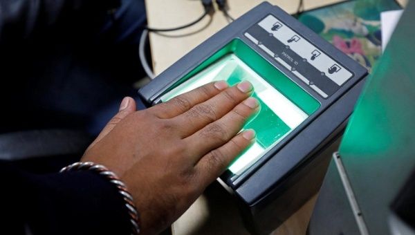 A woman goes through the finger scan process for the Unique Identification (UID) database system, aka Aadhaar, in New Delhi, India, Jan. 17, 2018.