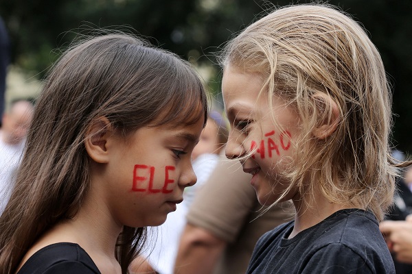 Kids with the distinctive 'Ele Nao' (Not Him) demand painted on their faces in Rio de Janeiro.
