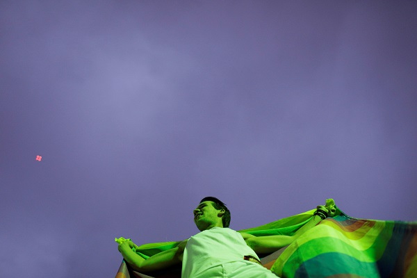 A man holds the flag representing the LGBT community at the protest in Rio de Janeiro..