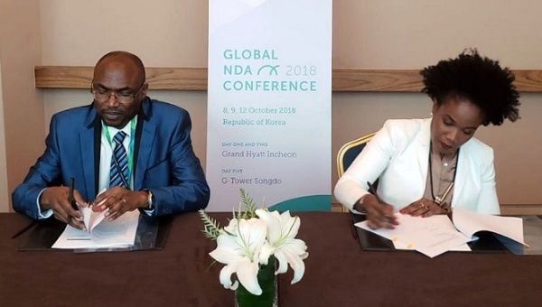 Jarju, a director of the Green Climate Fund, and Caddle, minister of economic affairs and investment, sign the Readiness Grant Agreement, South Korea.