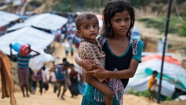 A young child clutches her younger brother as she looks for her family in the Kutupalong makeshift camp in Ukhia, Bangladesh on Oct. 24, 2017.