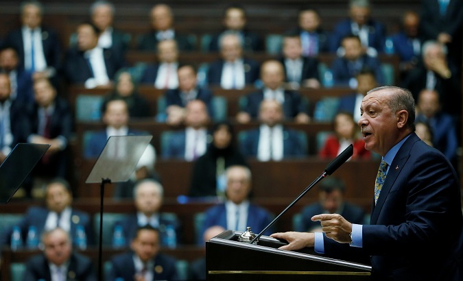 Turkish President Tayyip Erdogan addresses members during a meeting at the Turkish parliament in Ankara, Turkey Oct. 23, 2018.