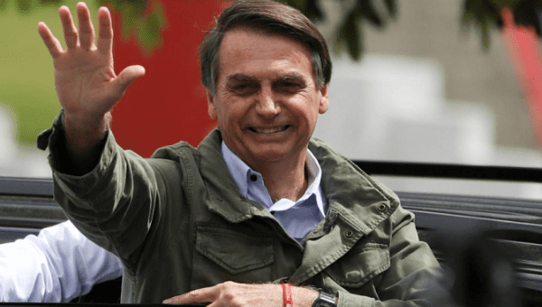 Jair Bolsonaro, far-right lawmaker and presidential candidate of the Social Liberal Party (PSL),waves at a polling station in Rio de Janeiro, Brazil October 28, 201