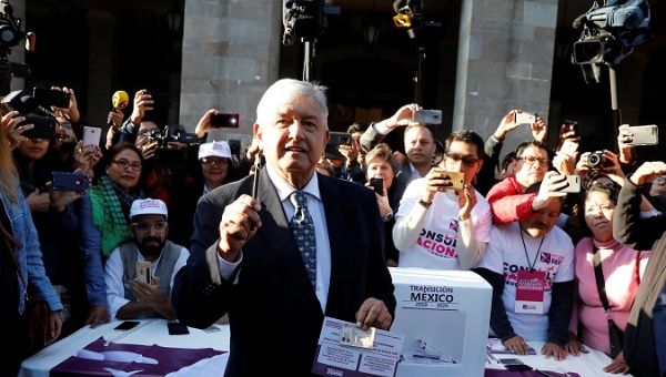Mexico's President-Elect Andres Manuel Lopez Obrador talks to reporters before casting his vote in a public consultation.