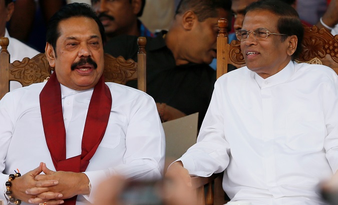 Sri Lanka's newly appointed Prime Minister Mahinda Rajapaksa and President Maithripala Sirisena talk during a rally in Colombo, Sri Lanka Nov. 5, 2018.