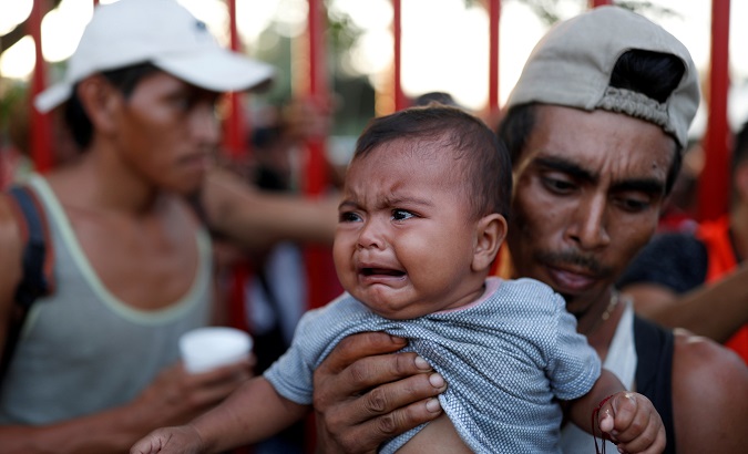 Santiago Monje, migrant of a caravan traveling to the United States, carries his daughter Tatiana.
