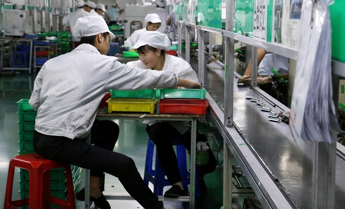 Employees work at a production line of lithium ion batteries inside a factory in Dongguan, China, Oct.16, 2018.