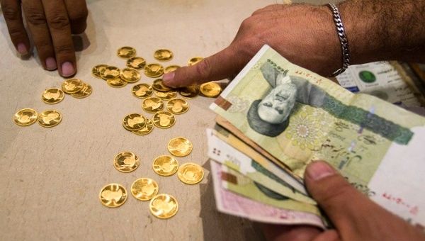 A customer buys Iranian gold coins at a currency exchange office in Tehran.