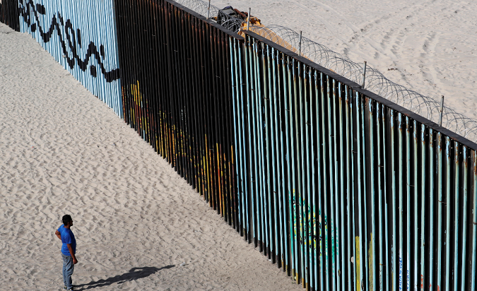 Central American Exodus member, migrant caravan looks at the border fence between Mexico and the US in Tijuana, Mexico November 15, 2018.