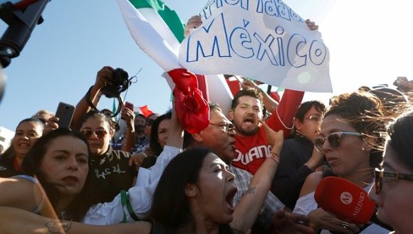 Anti-immigrant demonstrators hold signs reading 'Priority Mexico' as members of the migrant caravan arrive in Tijuana en route to the U.S. Tijuana, Mex Nov. 18, 2018.