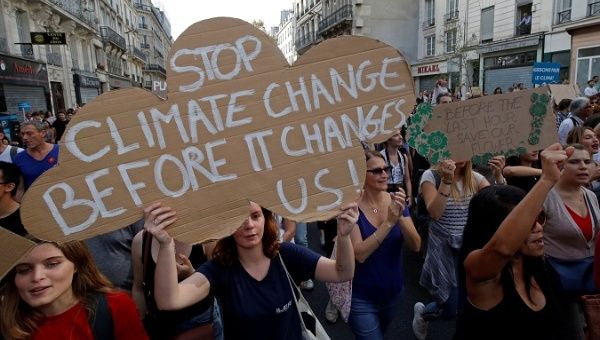 Protesters march to urge politicians to act against climate change in Paris Wednesday.