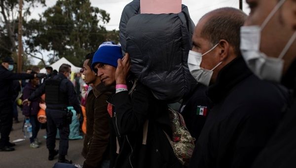 Central Americans seeking asylum in the U.S. wait to board a bus to be transferred to a new shelter in Tijuana, Mexico, Nov. 30, 2018|