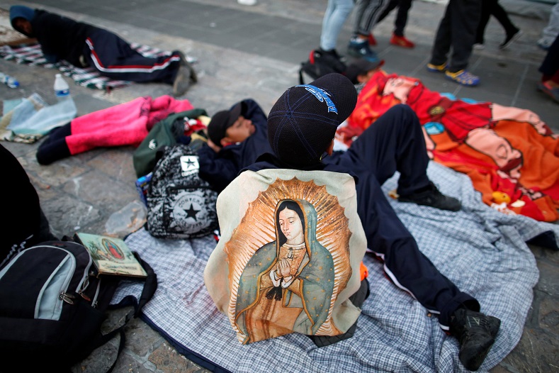 A boy is seen carrying an image of Guadalupe, similar to that at the Basilica, resting on his way. December 12, 2018.