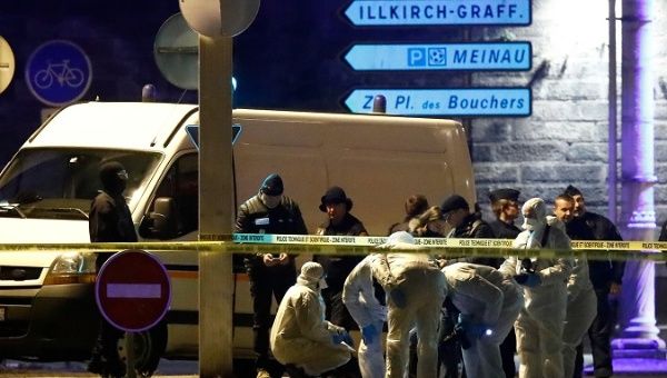 Investigators work on the street during a police operation in the Meinau in Strasbourg.