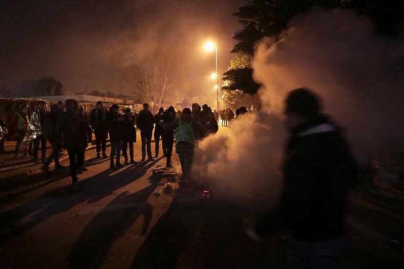 Smoke is seen after police extinguished a fire which demonstrators were warming up around, during a protest against a proposed new labor law, billed as the 