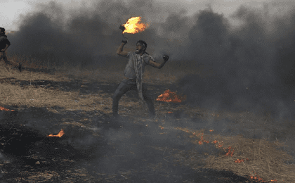 A Palestinian during clashes with Israeli troops at Israel-Gaza border, in the southern Gaza Strip April 3, 2018. 