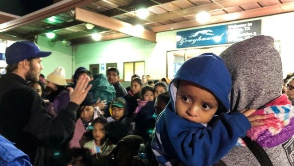 Some of over 200 migrants dropped off at a bus station by U.S. Immigration and Customs Enforcement (ICE), wait for transportation to shelters in El Paso, Texas, U.S. December 23, 2018. 