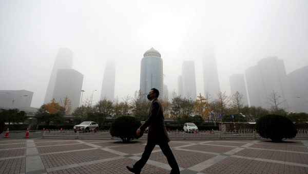 A man wearing a mask walks on a polluted day in Beijing, China, Nov. 14, 2018.