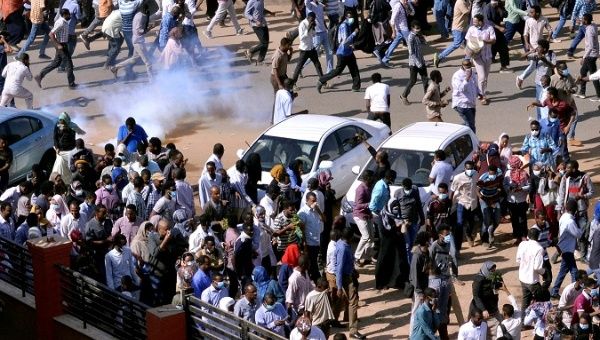  Sudanese demonstrators run from teargas during anti-government protests in Khartoum.