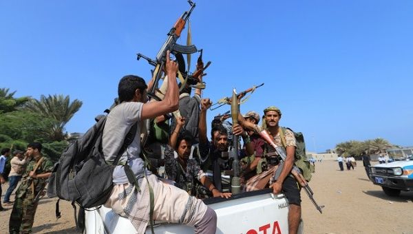 Houthi militants ride on the back of a truck as they withdraw from Hodeidah, part of a U.N.-sponsored peace agreement.