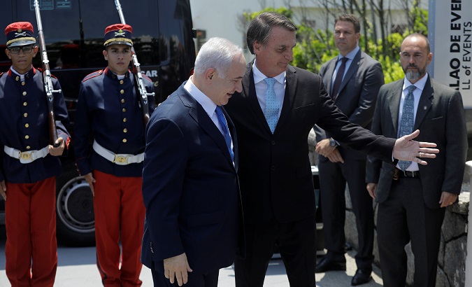 Brazil's President-elect Jair Bolsonaro greets Israeli Prime Minister Benjamin Netanyahu in Rio de Janeiro.