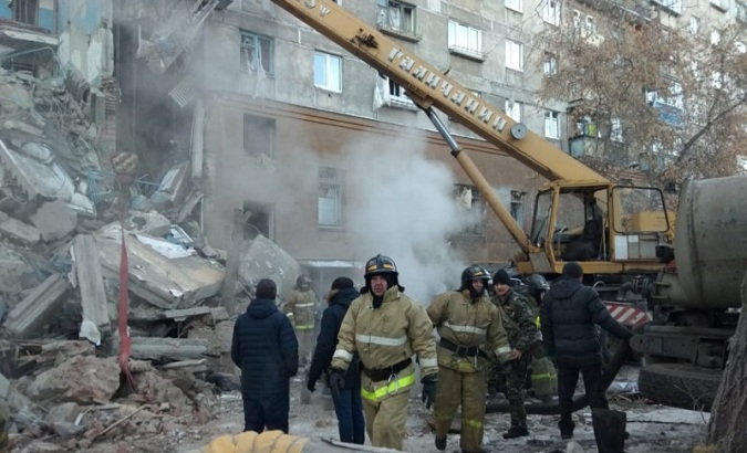 Emergency personnel work at the site of collapsed apartment building after a suspected gas blast in Magnitogorsk.