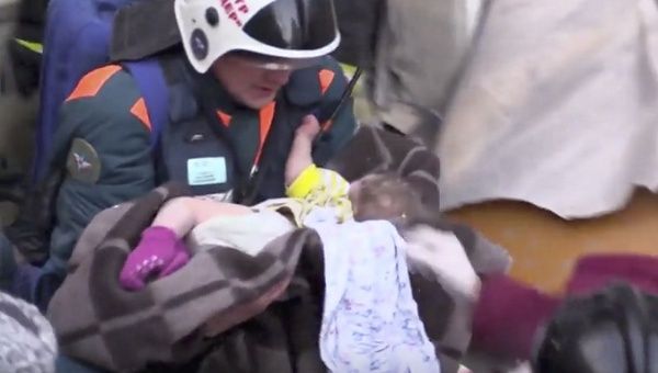 A still image taken from a video footage showsaA rescuer carries a 11-month-old child found alive in the rubble of a Russian apartment block that partially collapsed after a suspected gas blast in Magnitogorsk, Russia Jan. 1, 2019.